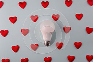 light love concept from hearts around light bulb on blue background minimalism