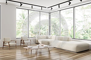 Light meeting room interior with couch and coffee table, panoramic window