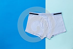 Light men`s boxers on a two-color background.