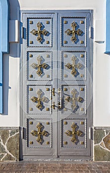 Light metal door with a cross