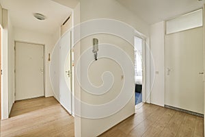 Light narrow hallway with doors