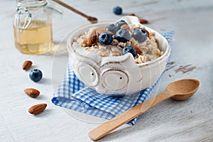 Light oatmeal breakfast with almond and blueberry