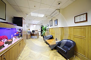Light office with armchairs and aquarium