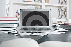Light office desktop with empty laptop monitor
