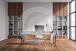 Light office interior with armchair and table, cabinet and panoramic window