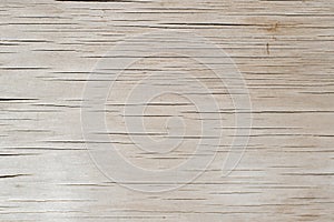 Light old brown plywood with horizontal cracks, textured wood background