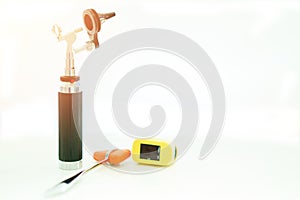 Light Otoscope ,Hammer jerk and digital Oximeter on blur background