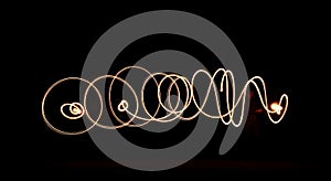 Light painting abstract spiral and wave pattern on black background