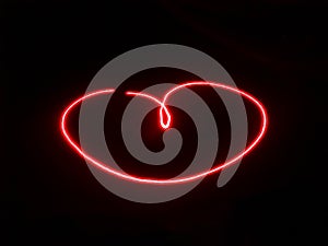 Light painting heart shape with red laser on black background