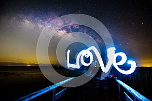 Light painting the LOVE word and milky way