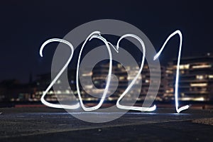 Light painting for the New Year\'s celebration: Writing 2021 with light into darkness