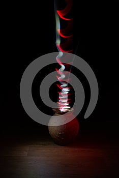 Light painting from old vase. Jing and jang in red and white light dance.