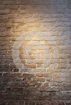 Light patch of light on the old plastered brick wall