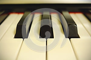 Light piano keyboard close up in white light