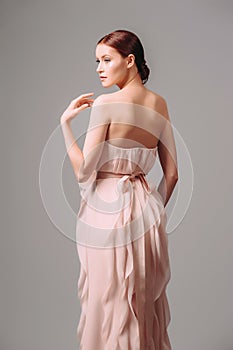 Light pink cocktail ruffled dress. Romantic backless evening gown