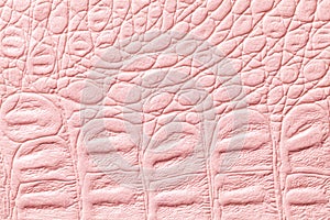 Light pink leather texture background, closeup. Reptile skin, macro