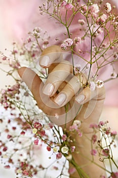 Light pink manicure on short nails.