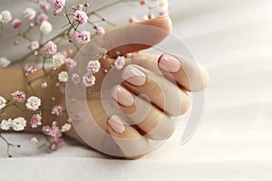Light pink manicure on short nails.