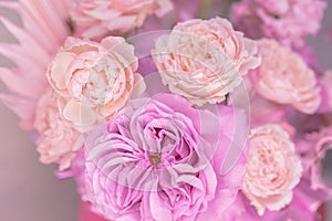 Light pink, purple, peach colour, white cute delicate small roses of different sizes, flowers in a lush bouquet.