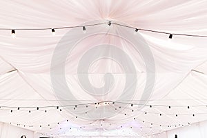 Light pink tent ceiling of the wedding ceremony