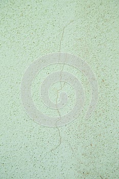 Light plastered wall with crack for background. Close up detale