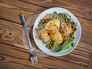 Light plate with chicken meatballs with rice and vegetables, canned green peas