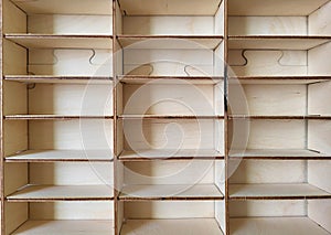 A light plywood empty shelf with many compartments.