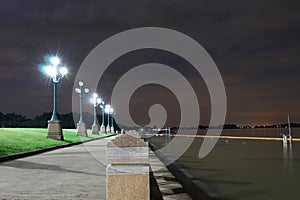 The light from a light pole at night in the park. at Riverwalk, lighting, seating, evening getaway landscape