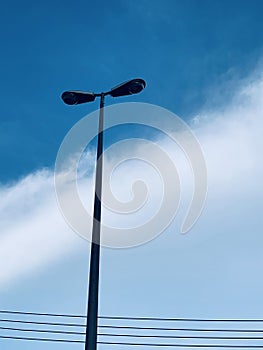 Light poles. Street lamp against blue sky background