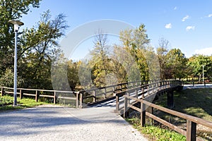 A light post and a wooden bridge in Bundek city park, Zagreb, Croatia