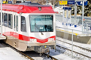 Light Rail Train Pulling out of a Snowy Station