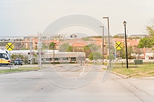 Light rail train speeding through a red alert sign level crossing