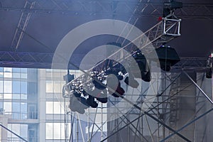 A light ramp suspended above the stage with floodlights and lighting fixtures, concert venues and equipment