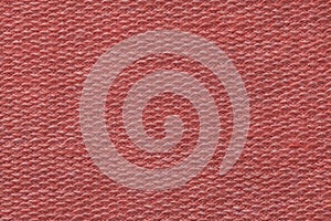 Light red background from a textile material. Fabric with natural texture. Backdrop.