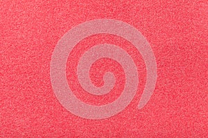 Light red matt suede fabric closeup. Velvet texture of felt