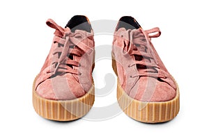 Light red suede sneakers white background isolated close up front view, stylish pink chamois gumshoes, pair of beige leather shoes