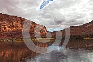 Light seeping through thick blanker of clouds at the Colorado river, Lees Ferry landing, Page, AZ, USA