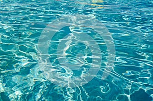 Light and shade ripples pattern in a swimming pool with turquoise clean water and vivid separatio lines