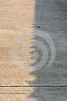 Light shadow on concrete road surface