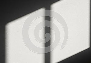 Light and shadow interplay on a textured surface, likely a wall, forming geometric patterns. The