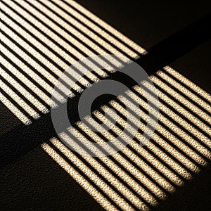 By sunlight filtering through window blinds, casting parallel lines