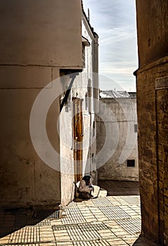 Light and shadow Sale. A street in the old city of Sale under the rays of the midday spring sun in front of a golden door