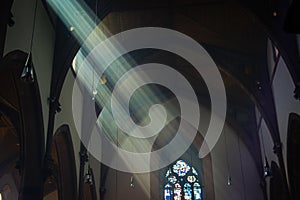 Light shafts stream into church window photo