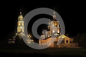 The light shines in the darkness. Kazan Cathedral and the bell tower of Diveevo Monastery at night