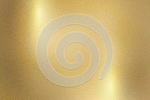 Light shining down on gold metal plate with copy space, abstract texture background