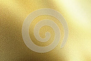 Light shining on gold foil metal board wall, abstract texture background