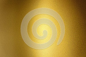 Light shining on gold metallic foil wall, abstract texture background