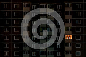 Light in a single window. Flat night panorama of multicolor light in windows of multistory buildings. life in big city