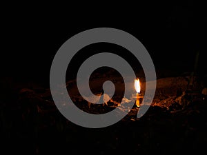 The light from a small lantern shone on the grass and stone photo