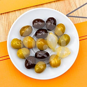 Light snack – oval bowl with pickled green olives and small onion